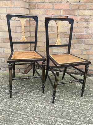 Lot 1037 - Pair of early 20th century gilt and ebonised bedroom chairs with caned seats