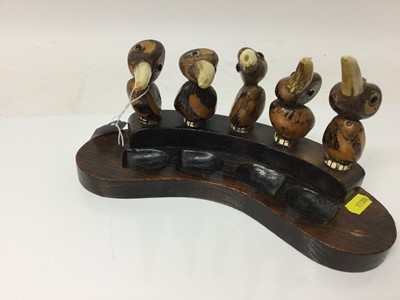 Lot 2342 - Unusual 1930s Art Deco period pipe rack, in the style of Henry Howell YZ, made up of five Tagua Nut Birds, with antler beaks, to hold four pipes, on a shaped oak base, 27cm across