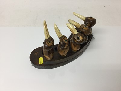 Lot 2342 - Unusual 1930s Art Deco period pipe rack, in the style of Henry Howell YZ, made up of five Tagua Nut Birds, with antler beaks, to hold four pipes, on a shaped oak base, 27cm across