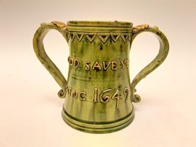 Lot 1131 - Castle Hedingham Edward Bingham green glazed pottery two handled tankard decorated with script - God Save Ye King 1649 and Drink Faire Dont Sware, 14cm high