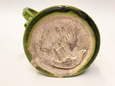 Lot 1131 - Castle Hedingham Edward Bingham green glazed pottery two handled tankard decorated with script - God Save Ye King 1649 and Drink Faire Dont Sware, 14cm high