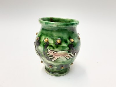 Lot 1133 - Castle Hedingham Edward Bingham green glazed pottery vase decorated with a band of four running animals, 11cm high