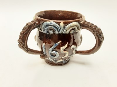 Lot 1134 - Castle Hedingham Edward Bingham brown glazed three handled cup decorated with GR, BV and 1653, 9cm high