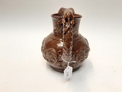 Lot 90 - Castle Hedingham Edward Bingham brown glazed pottery jug, with lion on handle and mask decoration, 22cm high