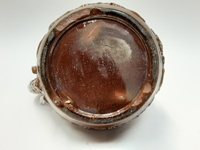 Lot 90 - Castle Hedingham Edward Bingham brown glazed pottery jug, with lion on handle and mask decoration, 22cm high