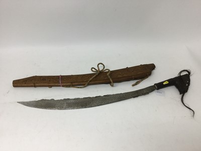 Lot 978 - Borneo Dayak Head hunters sword with steel blade, carved ebonised wood hilt, in ornately carved wood scabbard