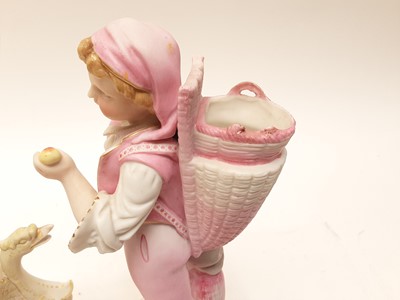 Lot 88 - Bisque porcelain figure of a boy carrying a basket on his back, and a bisque porcelain cherub riding a sledge (2)
