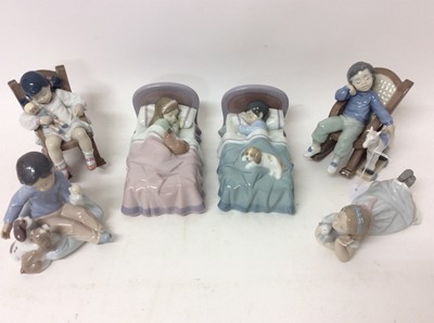 Lot 1177 - Six Lladro porcelain figures - girl in bed, boy in bed, girl on rocking chair, boy on rocking chair, girl with kitten and boy with dogs