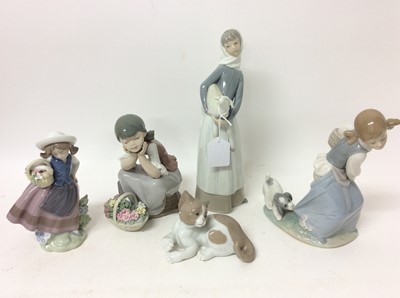 Lot 1179 - Five Lladro porcelain figures - lady with lamb, girl with flowers x 2, girl with puppy and a cat