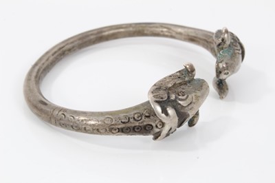 Lot 218 - Persian silver/white metal torque bangle with rams head terminals