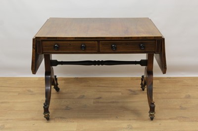 Lot 1470 - Regency rosewood sofa table with satinwood crossbanded top on end standards