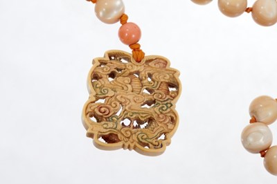 Lot 535 - Late 19th century Chinese carved ivory pendant necklace with spherical mother-of-pearl beads