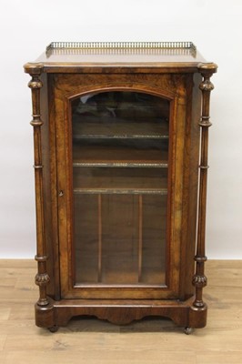 Lot 1435 - Victorian inlaid burr walnut veneered music cabinet with pierced gilded brass gallery, crossbanded top, original shelved interior enclosed by arched glazed door flanked by carved and fluted turned...