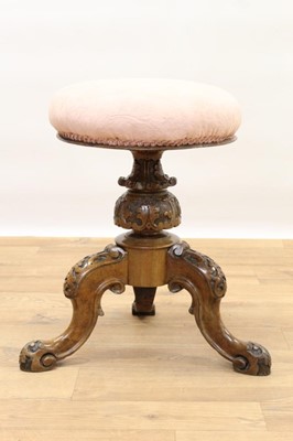 Lot 1436 - Victorian carved walnut piano stool with circular revolving seat on carved and turned bulbous support on three carved hipped scroll legs