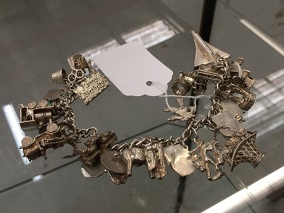 Lot 661 - Vintage silver charm bracelet with a collection of novelty charms