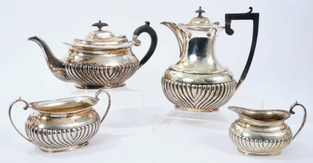 Lot 249 - Silver three piece tea set with half fluted decoration,  together with a silver plated coffee pot