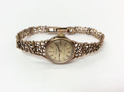 Lot 672 - 9ct gold ladies Tissot Stylist wristwatch on 9ct gold open work hinged bracelet