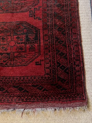 Lot 973 - An antique Eastern rug with geometric medallions on blue and red ground, 130cm x 82cm, together with another on red ground, 118cm x 88cm (2)