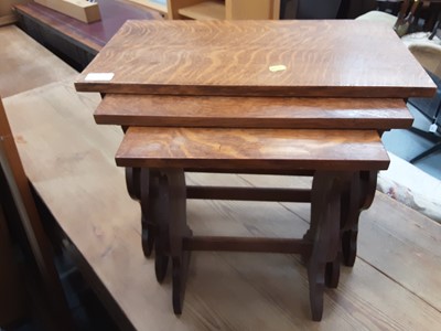 Lot 873 - Oak drop leaf table on turned end standards and a nest of three oak occasional tables