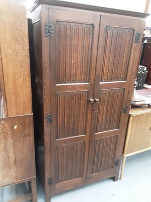 Lot 879 - 17th century style oak wardrobe enclosed by two linenfold panelled doors