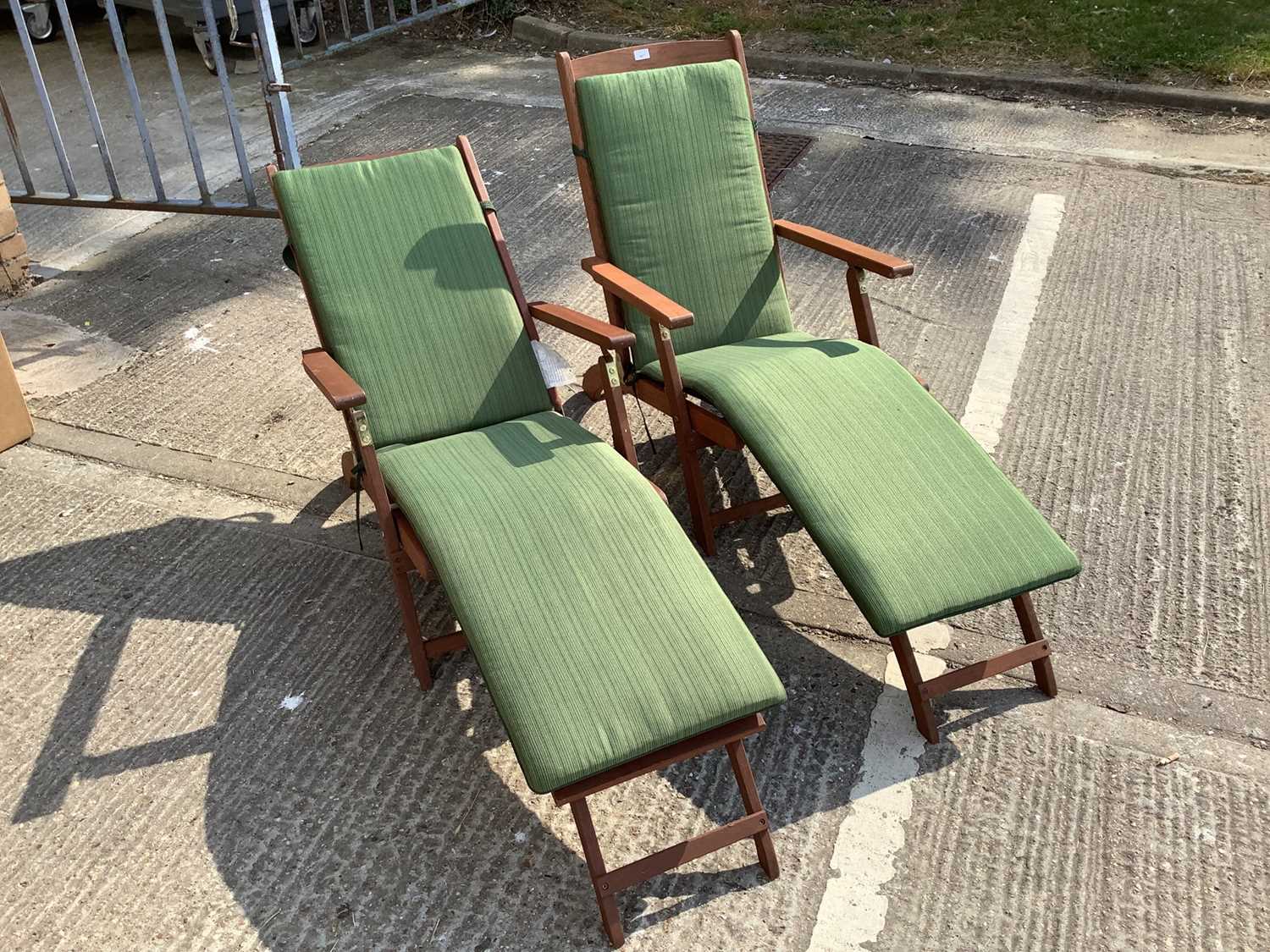 Lot 947 - Pair of modern teak steamer chairs of typical form, with green fabric cushions