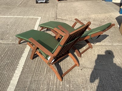 Lot 947 - Pair of modern teak steamer chairs of typical form, with green fabric cushions