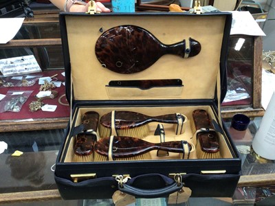 Lot 580 - Faux tortoiseshell dressing table set with gilt Q initial, in a good quality fitted leather case inside a further canvas case