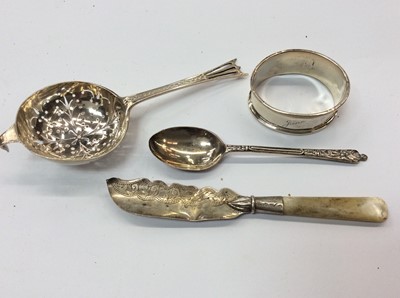 Lot 741 - Group of silver to include tea strainer, napkin ring, teaspoon and butter knife