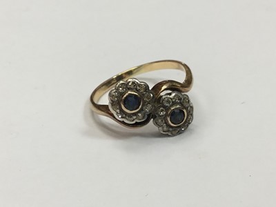 Lot 687 - Edwardian sapphire and diamond double flower head cluster ring with cross-over setting on yellow gold shank. Finger size O.