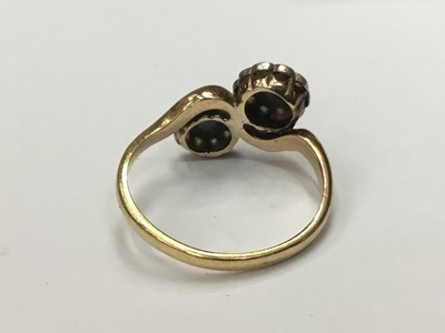 Lot 687 - Edwardian sapphire and diamond double flower head cluster ring with cross-over setting on yellow gold shank. Finger size O.