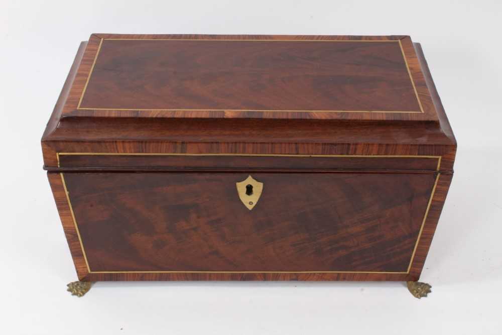 Lot 790 - George III mahogany inlaid sarcophagus shape tea caddy with rosewood crossbanding and inlaid brass stringing, original fitted tea canisters on lion's paw feet