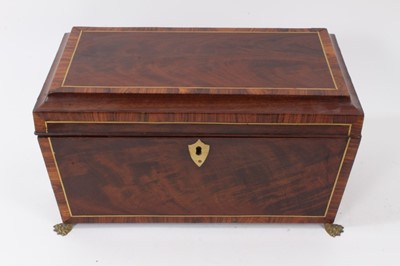Lot 790 - George III mahogany inlaid sarcophagus shape tea caddy with rosewood crossbanding and inlaid brass stringing, original fitted tea canisters on lion's paw feet