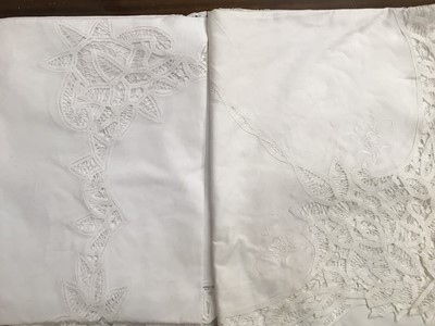 Lot 546 - Two fine cotton white embroidered table cloths, plus two ivory linen embroidered table cloths with several napkins