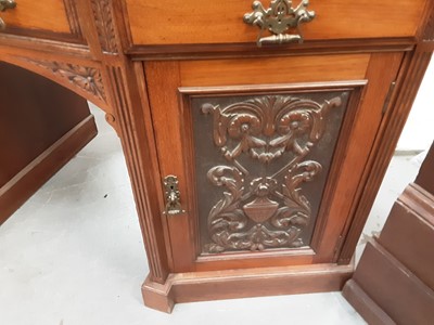 Lot 885 - Good quality late Victorian/Edwardian carved walnut kneehole desk with leather lined top, three drawers and two carved panelled doors below, 143cm wide, 61cm deep, 80cm high