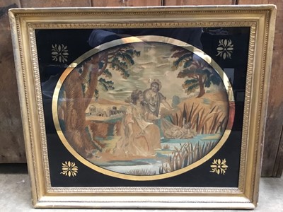 Lot 229 - George III needlework and silk picture depicting baby Moses in the cradle, in original verre églomisé glazed gilt frame