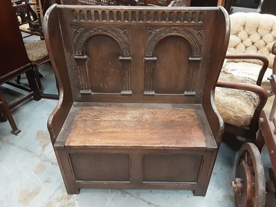 Lot 943 - Carved oak hall bench with carved panelled back and rising lid to seat, 86cm wide, 42cm deep, 103cm high