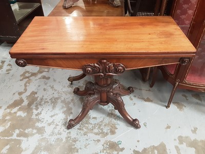 Lot 983 - Early Victorian mahogany tea table with fold over revolving top on turned and reeded pedestal with four carved scroll legs