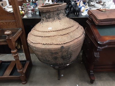 Lot 1001 - Large terracotta garden pot on wrought iron stand, approximately 110cm high