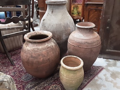 Lot 1005 - Four terracotta garden pots, largest is 79cm high