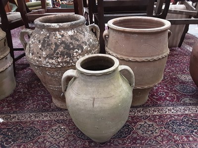 Lot 1006 - Three terracotta two handled garden pots, tallest is 55cm high