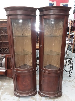 Lot 1017 - Pair of good quality mahogany and walnut veneered corner cupboards with glazed and panelled doors, 63cm wide, 198cm high