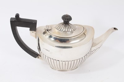 Lot 212 - 1920s silver half fluted teapot.
