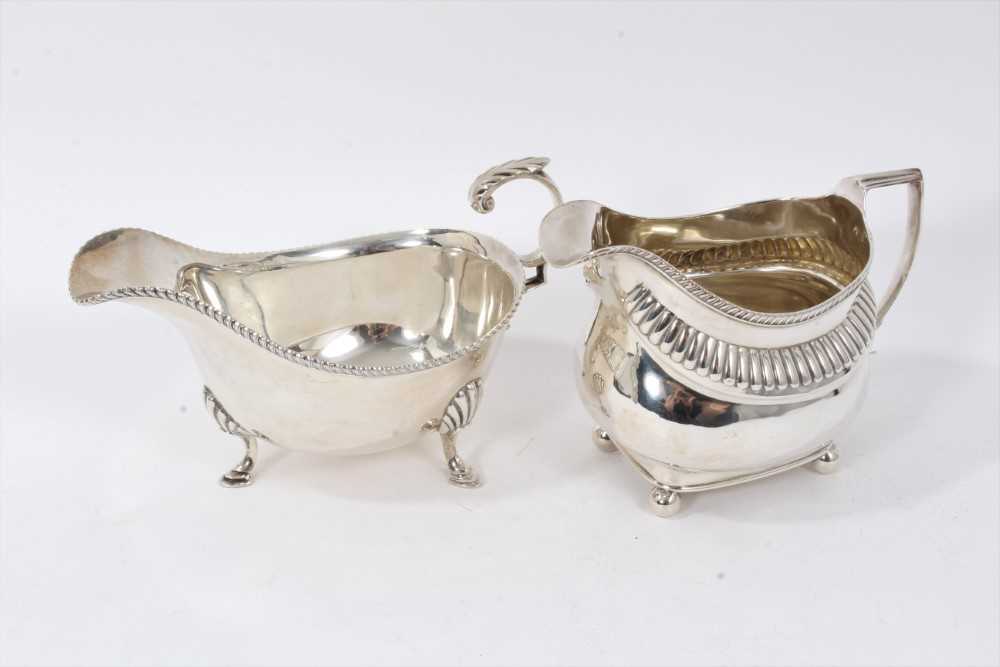 Lot 215 - Silver sauceboat together with a cream jug