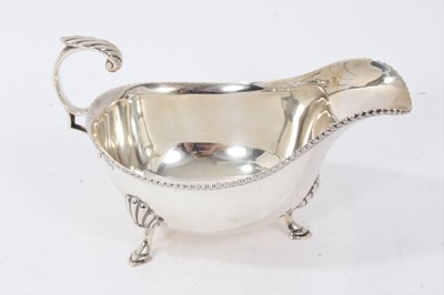 Lot 215 - Silver sauceboat together with a cream jug