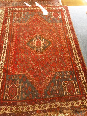 Lot 1024 - Eastern rug with geometric decoration on red and blue ground, 235cm x 154cm