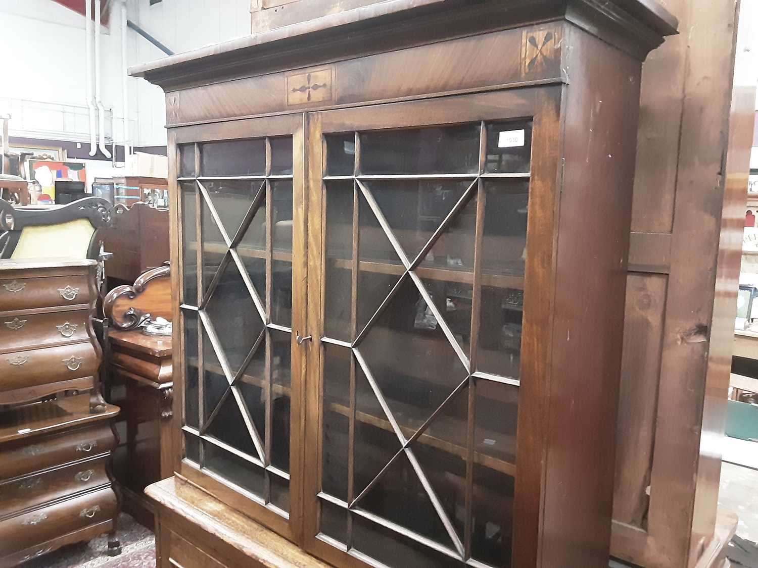 Lot 872 - Regcncy and later mahogany and oak two height bookcase, the upper earlier section enclosed by a pair of astragal glazed doors, the base enclosed by two panelled doors, 110cm wide x 35cm deep x 192c...