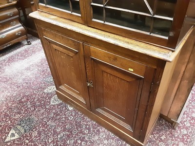 Lot 872 - Regcncy and later mahogany and oak two height bookcase, the upper earlier section enclosed by a pair of astragal glazed doors, the base enclosed by two panelled doors, 110cm wide x 35cm deep x 192c...