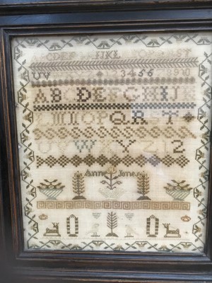 Lot 490 - Three 19th century needlework samplers, each in glazed frame, the largest on white ground 43 x 38cm. (3)