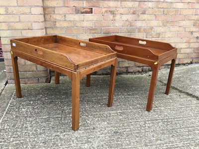 Lot 1038 - Two mahogany butlers tray occasional tables on stands, each of typical form