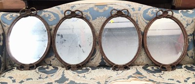 Lot 1490 - Rare set of four Regency oval gilt wall mirrors